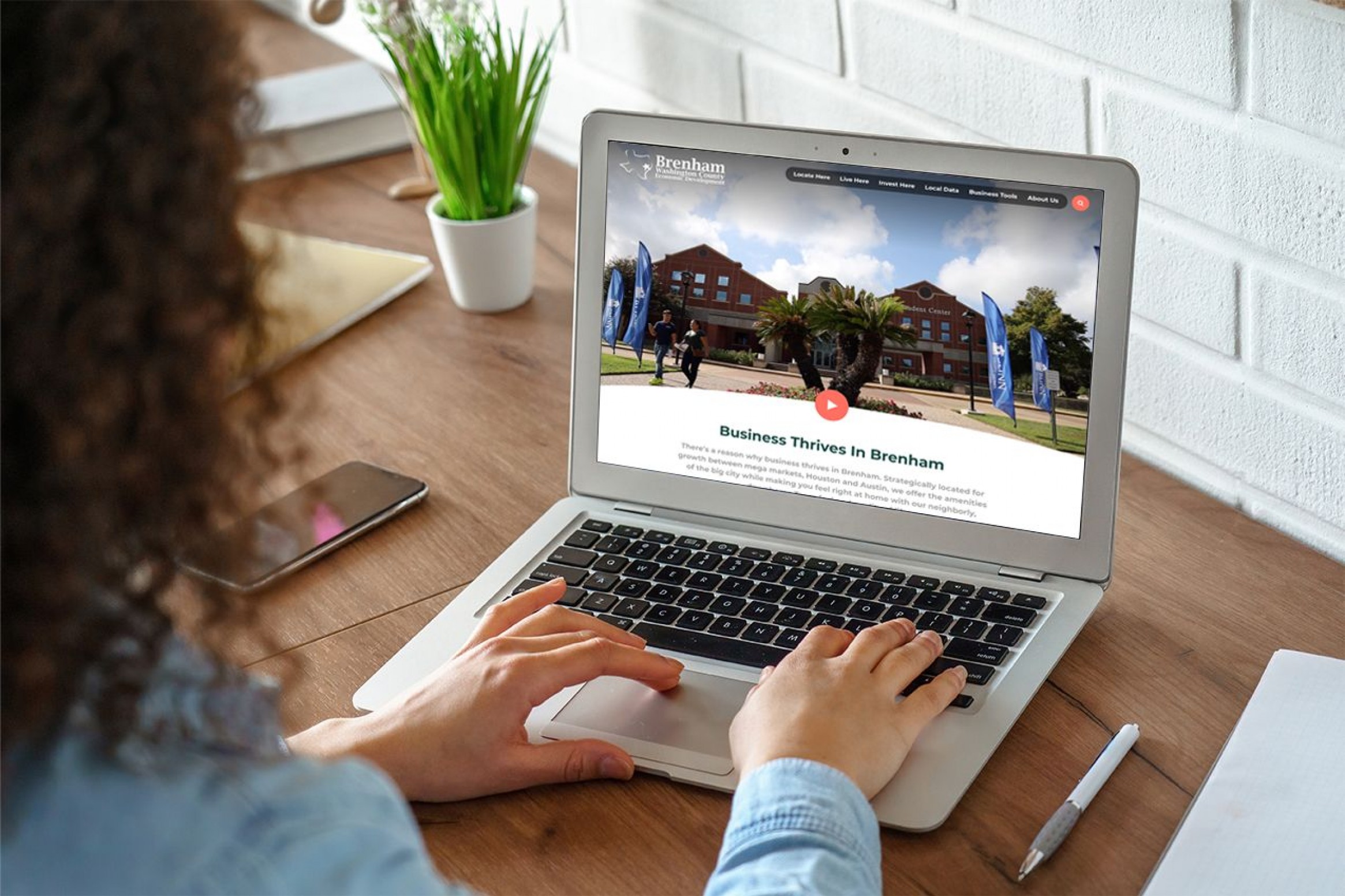 Brenham's Business page on a woman's computer