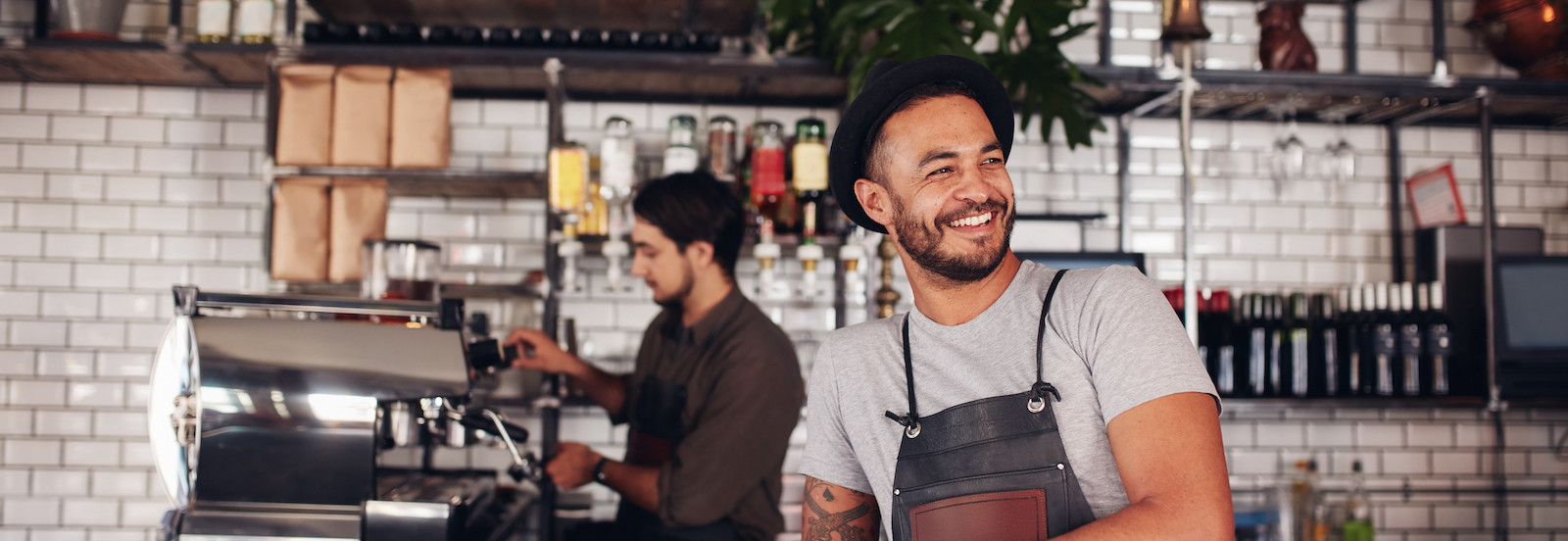 Man standing in front of a counter at a coffee shop