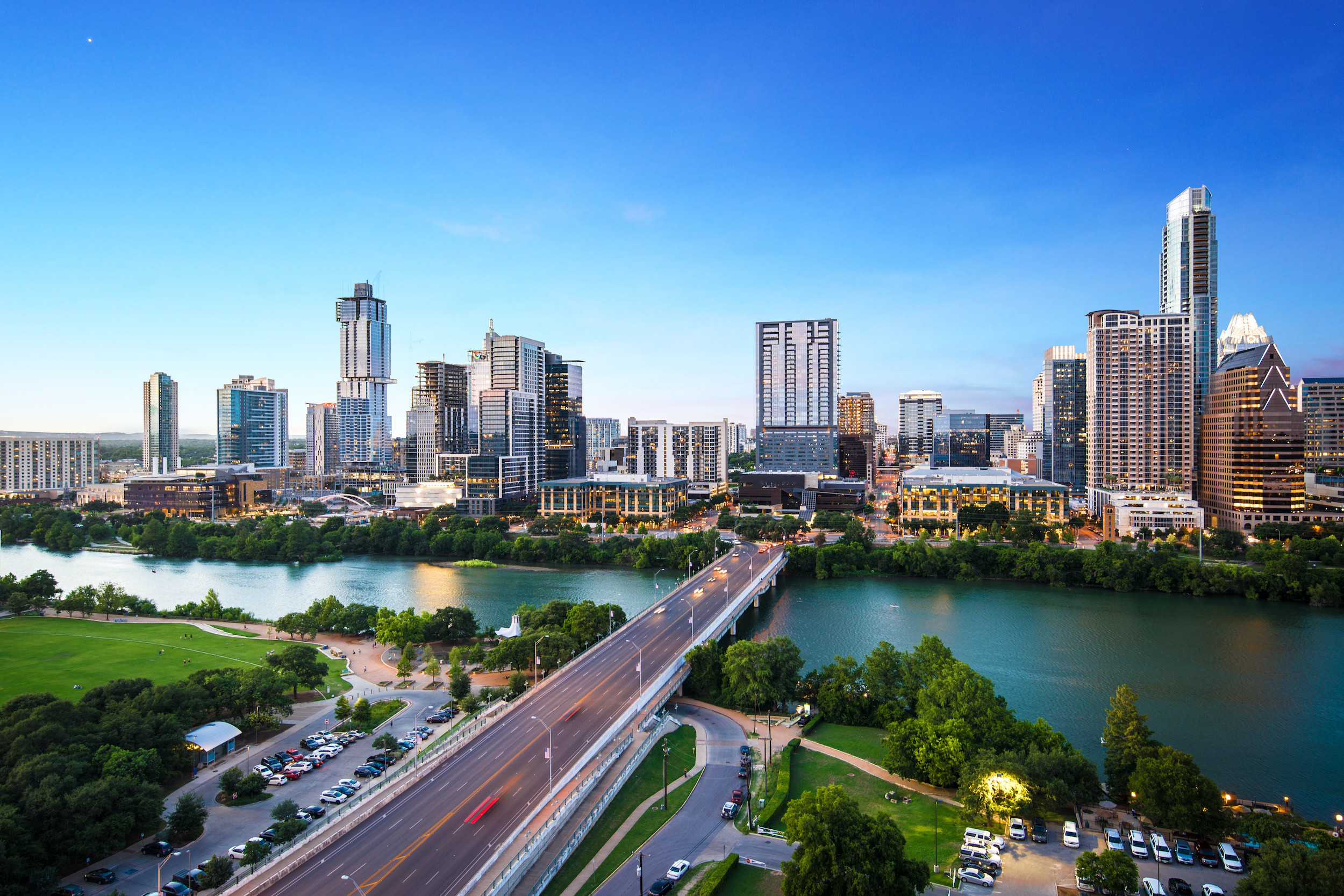 Photo of a bridge with a city skyline in the background