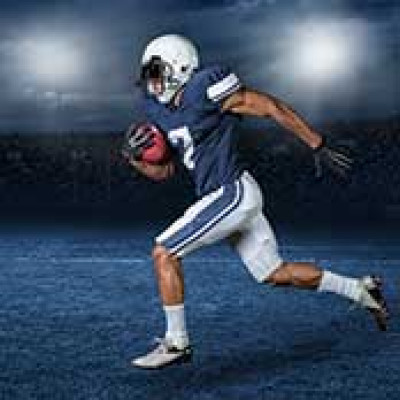 A football player running with a football